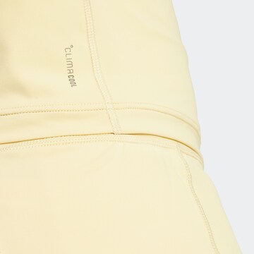 Top sportivo 'OPTIME' di ADIDAS PERFORMANCE in giallo