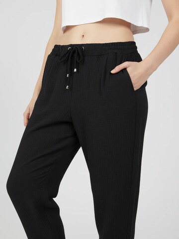 No Matter What Tapered Pleat-front trousers in Black