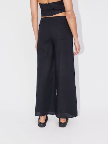 ABOUT YOU REBIRTH STUDIOS Wide leg Trousers 'Holiday' in Black