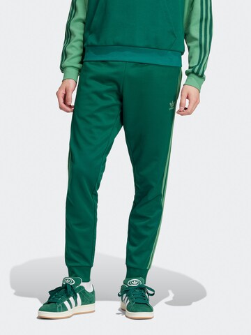ADIDAS ORIGINALS Tapered Pants 'Adicolor Classics Sst' in Green: front