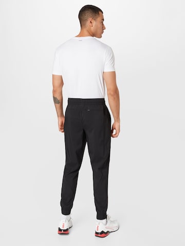 PUMA Tapered Sportbroek 'Train Vent' in Zwart