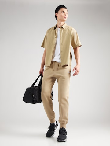 Nike Sportswear Tapered Trousers 'CLUB' in Beige