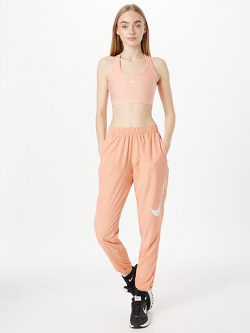 NIKE Regular Workout Pants in Red