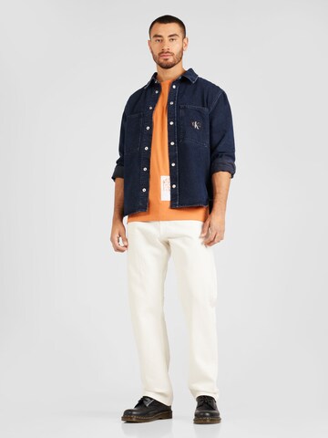 Calvin Klein Jeans Μπλουζάκι 'STENCIL' σε πορτοκαλί