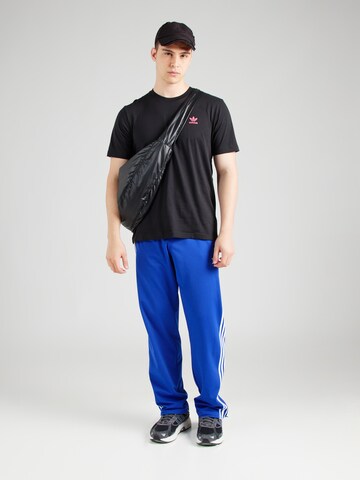ADIDAS ORIGINALS Paita 'Training Supply Fashion Arty' värissä musta