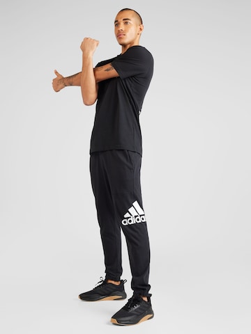 ADIDAS SPORTSWEAR - Tapered Calças de desporto 'ESS' em preto