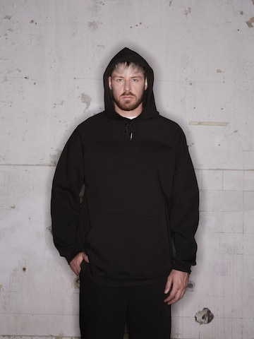 ABOUT YOU x Rewinside Zip-Up Hoodie 'Marco' in Black: front