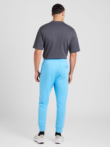 Nike Sportswear Tapered Broek 'CLUB' in Blauw