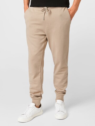 Calvin Klein Jeans Zúžený Kalhoty – béžová: přední strana