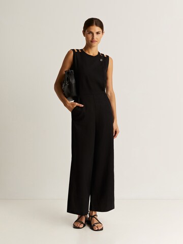 Scalpers Jumpsuit in Black: front