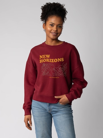 Watapparel Sweatshirt 'New horizons are everywhere ' in Rood: voorkant