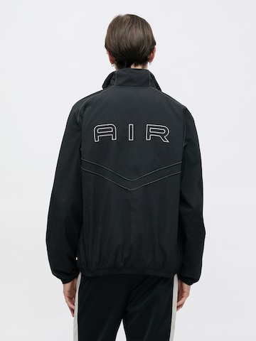 Veste mi-saison 'AIR' Nike Sportswear en noir : devant