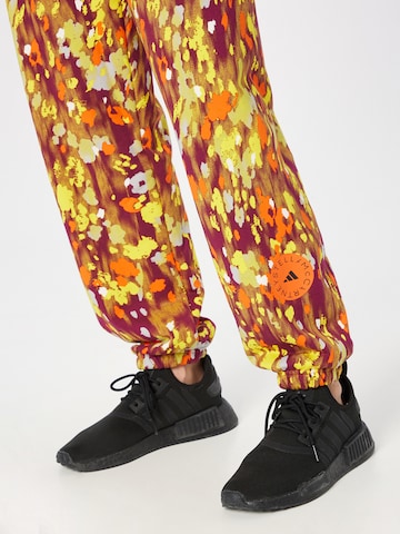 ADIDAS BY STELLA MCCARTNEY - Tapered Calças de desporto 'Floral Printed ' em laranja