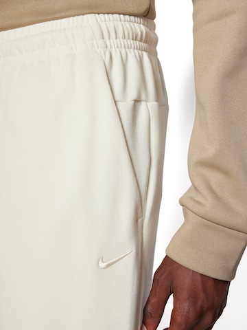 NIKE Tapered Sports trousers 'PRIMARY' in Beige
