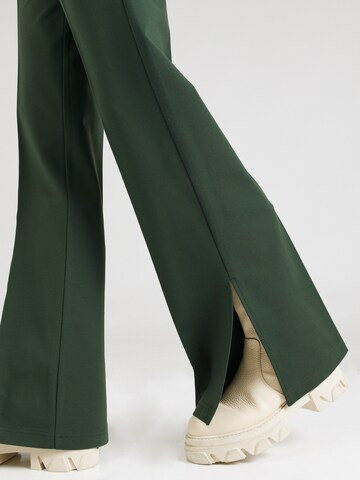 florence by mills exclusive for ABOUT YOU Flared Παντελόνι με τσάκιση 'Tela' σε πράσινο