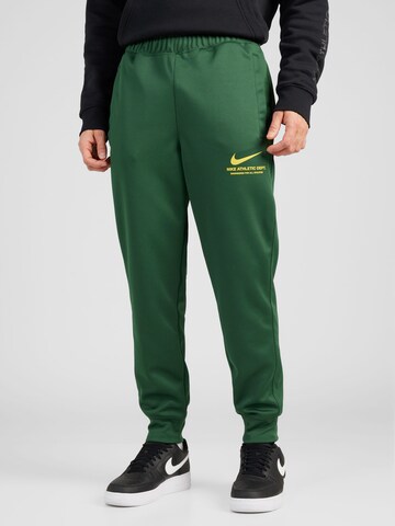 Nike Sportswear Tapered Pants in Green: front