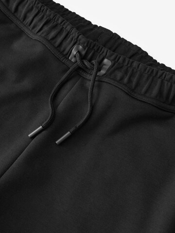 Tapered Pantaloni funzionali di Next in nero