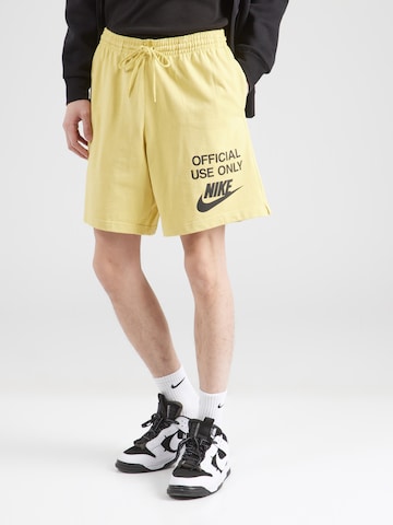 Nike Sportswear Loose fit Trousers 'CLUB OFFICIAL' in Yellow: front