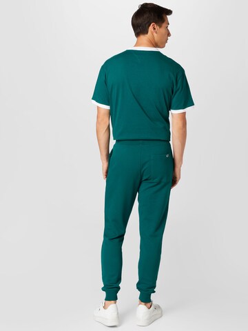 Tommy Jeans Zwężany krój Spodnie w kolorze zielony