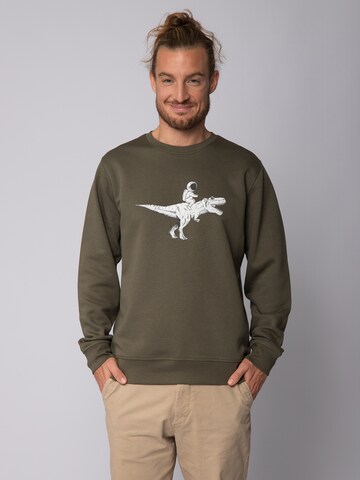 Watapparel Sweatshirt ' Astronaut on T-Rex ' in Groen: voorkant