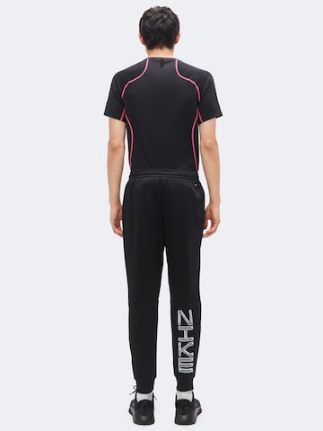 Effilé Pantalon de sport 'Flex' NIKE en noir