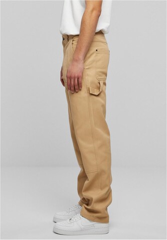 Karl Kani Regular Trousers in Beige