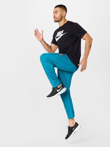 Effilé Pantalon de sport NIKE en bleu