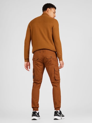 ruda Calvin Klein Jeans Siauras Laisvo stiliaus kelnės
