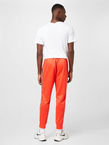 Nike Sportswear Tapered Trousers in Red