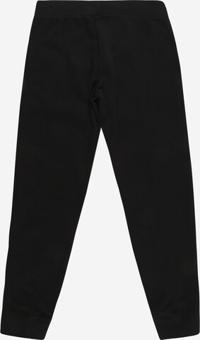 Tapered Pantaloni di Nike Sportswear in nero