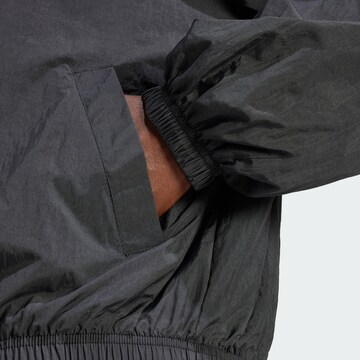 ADIDAS ORIGINALS Übergangsjacke  'Essentials' in Schwarz