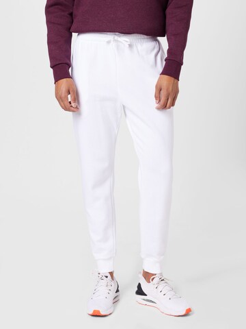 Effilé Pantalon de sport UNDER ARMOUR en blanc : devant