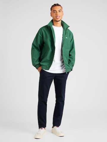 Tommy Jeans Övergångsjacka 'ESSENTIAL' i grön