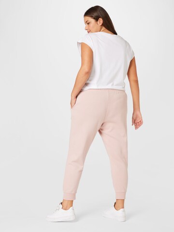 Nike Sportswear Tapered Sports trousers in Pink