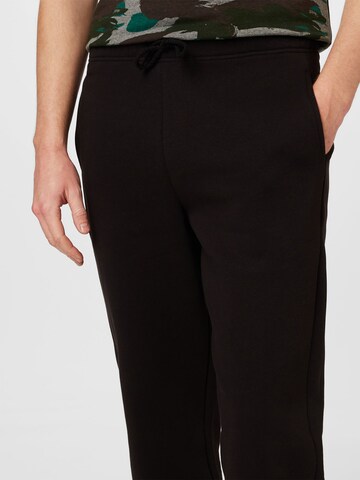 ABOUT YOU - Tapered Pantalón 'Jake' en negro