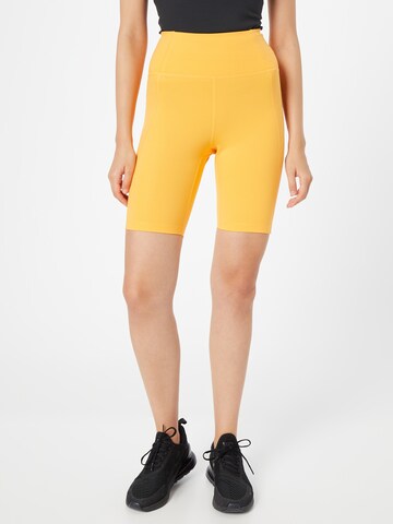 Girlfriend Collective Skinny Workout Pants in Orange: front