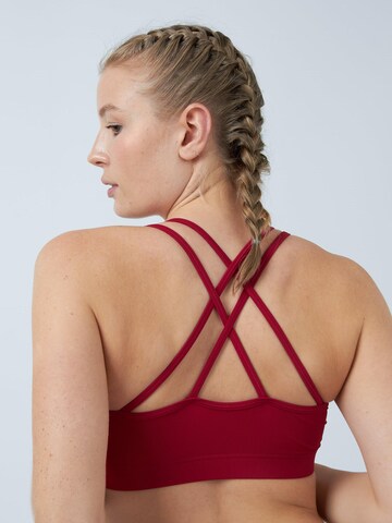 SPORTKIND Medium support Sport bh 'Crossed Straps' in Rood
