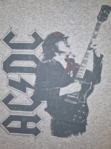 AC/DC Koszulka 'Angus Solo' w kolorze szary