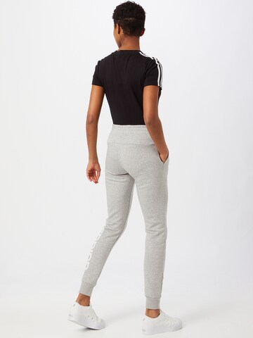 ADIDAS SPORTSWEAR Tapered Workout Pants 'Essentials Fleece Logo' in Grey