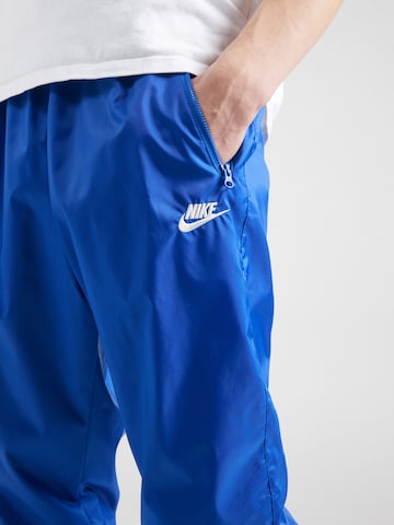 Nike Sportswear - Tapered Calças 'Windrunner' em azul