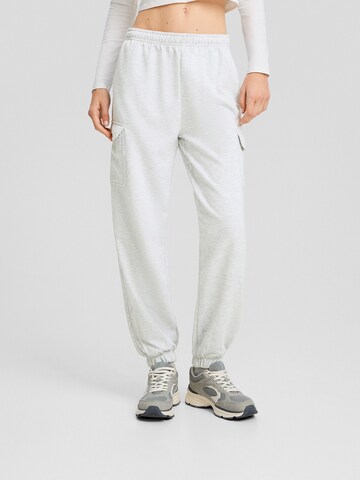 Bershka Tapered Pants in Grey: front