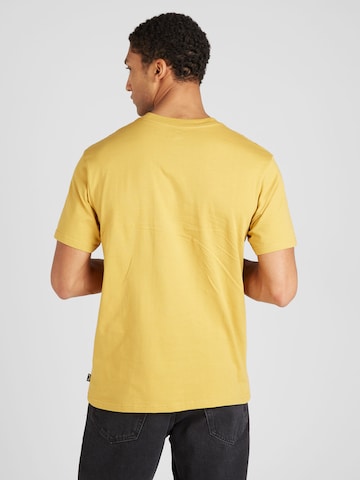 BILLABONG - Camiseta 'TEAM WAVE' en oro