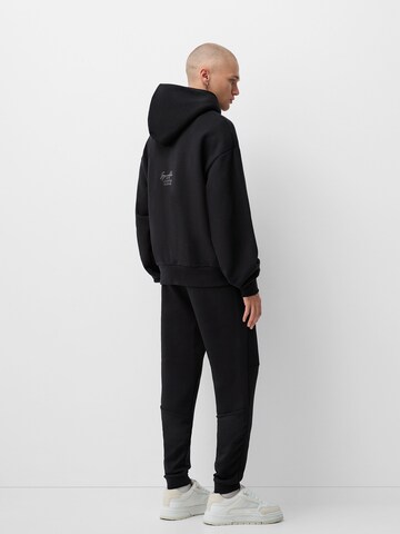 Bershka Tapered Bukser i sort