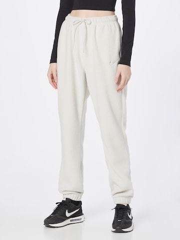 Nike Sportswear Tapered Pants in Beige: front