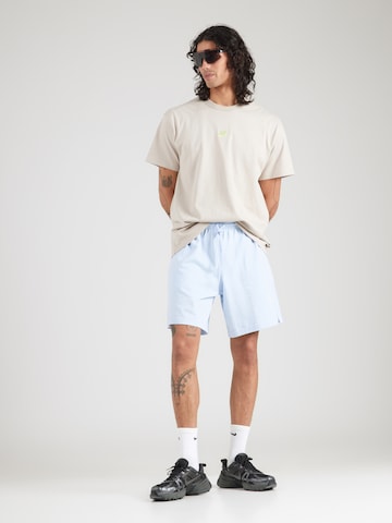 Loosefit Pantalon 'Club' Nike Sportswear en bleu