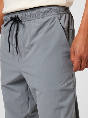 NIKE Tapered Workout Pants 'UNLIMITED' in Grey