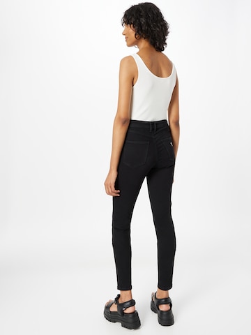 Skinny Jeans di GUESS in nero