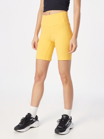 UNDER ARMOUR Slim fit Workout Pants 'Meridian' in Yellow: front