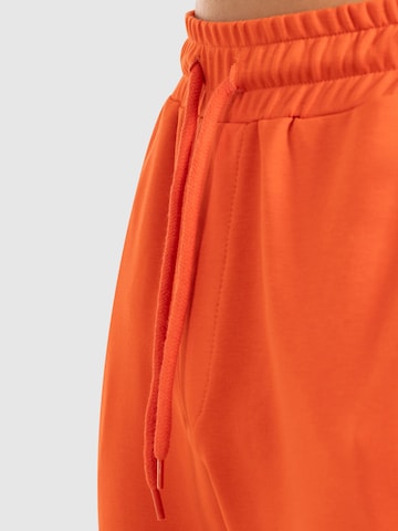 Effilé Pantalon de sport 'Nilo' Smilodox en orange