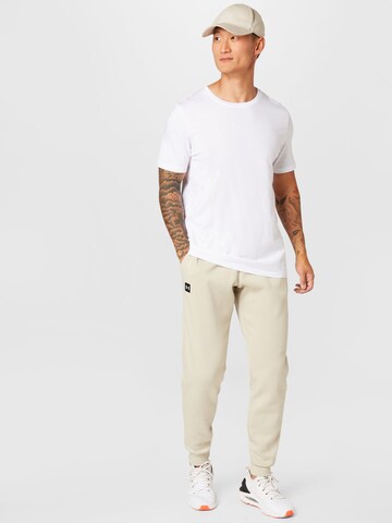 UNDER ARMOUR Tapered Urheiluhousut 'Rival' värissä vihreä